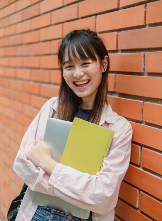 A lady with book and big smile