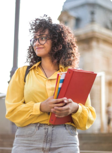 A girl with books and smile on her face